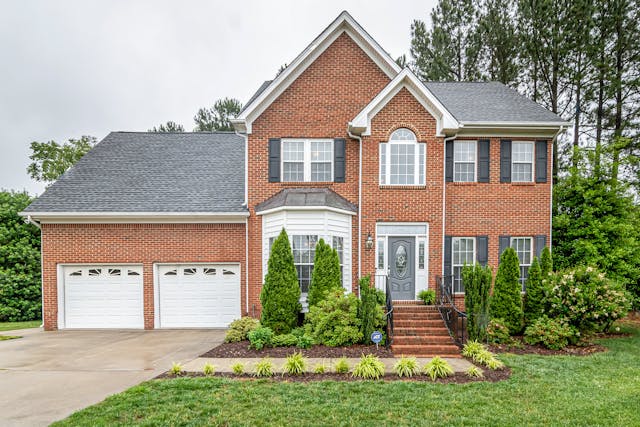 Exterior of a brick home with greenery