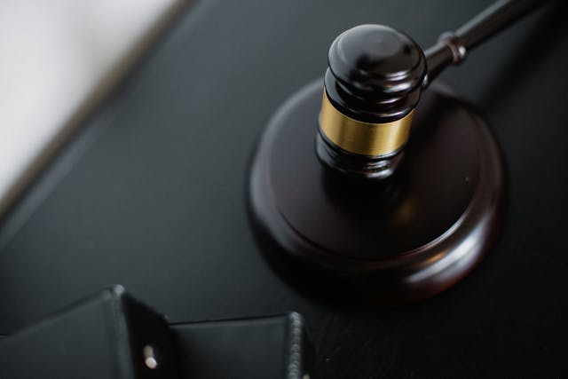 gavel sitting on a wooden plate