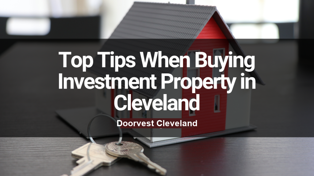 A model house with red and white walls and a grey roof sits on a table. In front are two keys on a keyring. Text overlay reads, "Top Tips When Buying Investment Property in Cleveland - Doorvest Cleveland."
