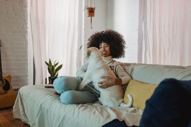 a person sitting on a couch with a dog