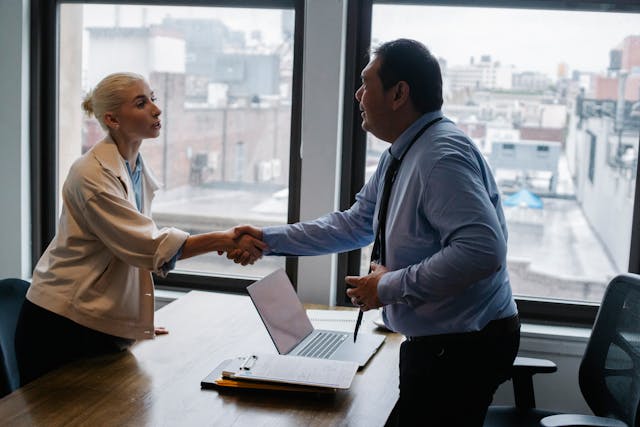 person shaking hands with a property manager