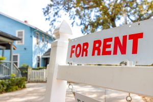A close up shot of a "For Rent" sign