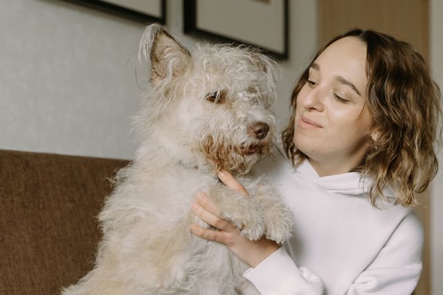 person with a dog on the couch